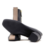 Sylven Jayne Black/Taupe Vegan apple leather boots - one shoe upside down shot