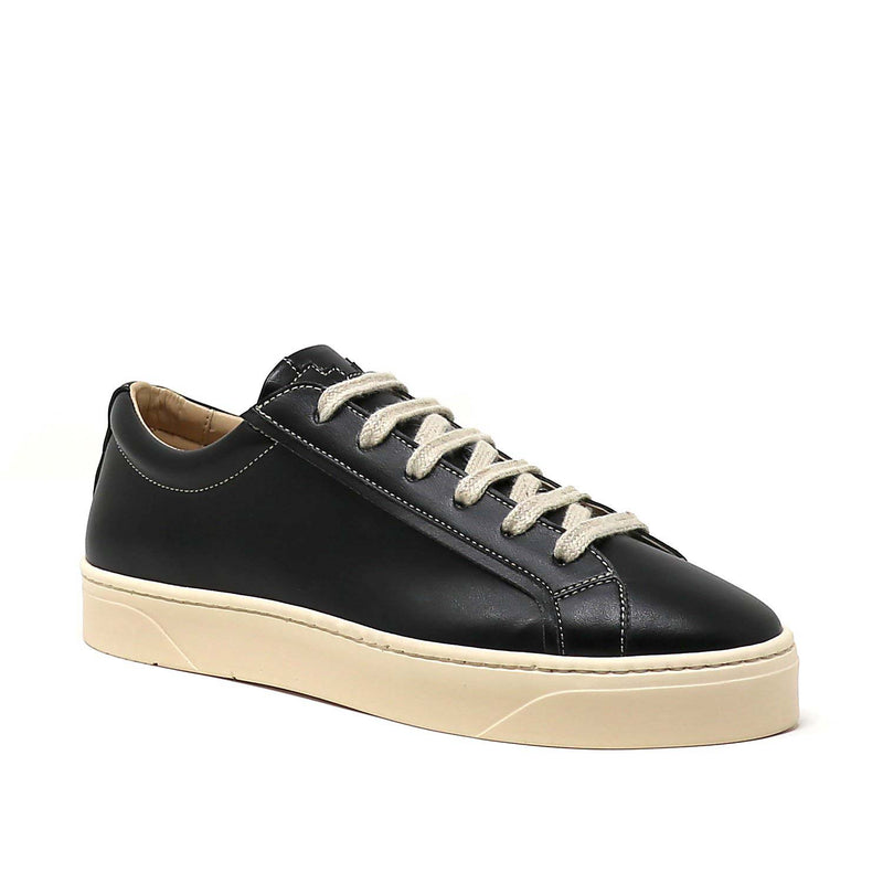 Sylven Mel Black/Oat vegan apple leather sneakers - one shoe shown sideways